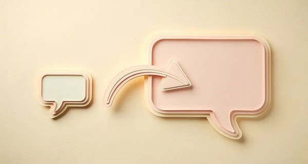 Two paper-craft speech bubbles connected by an arrow, representing a cold email reply exchange